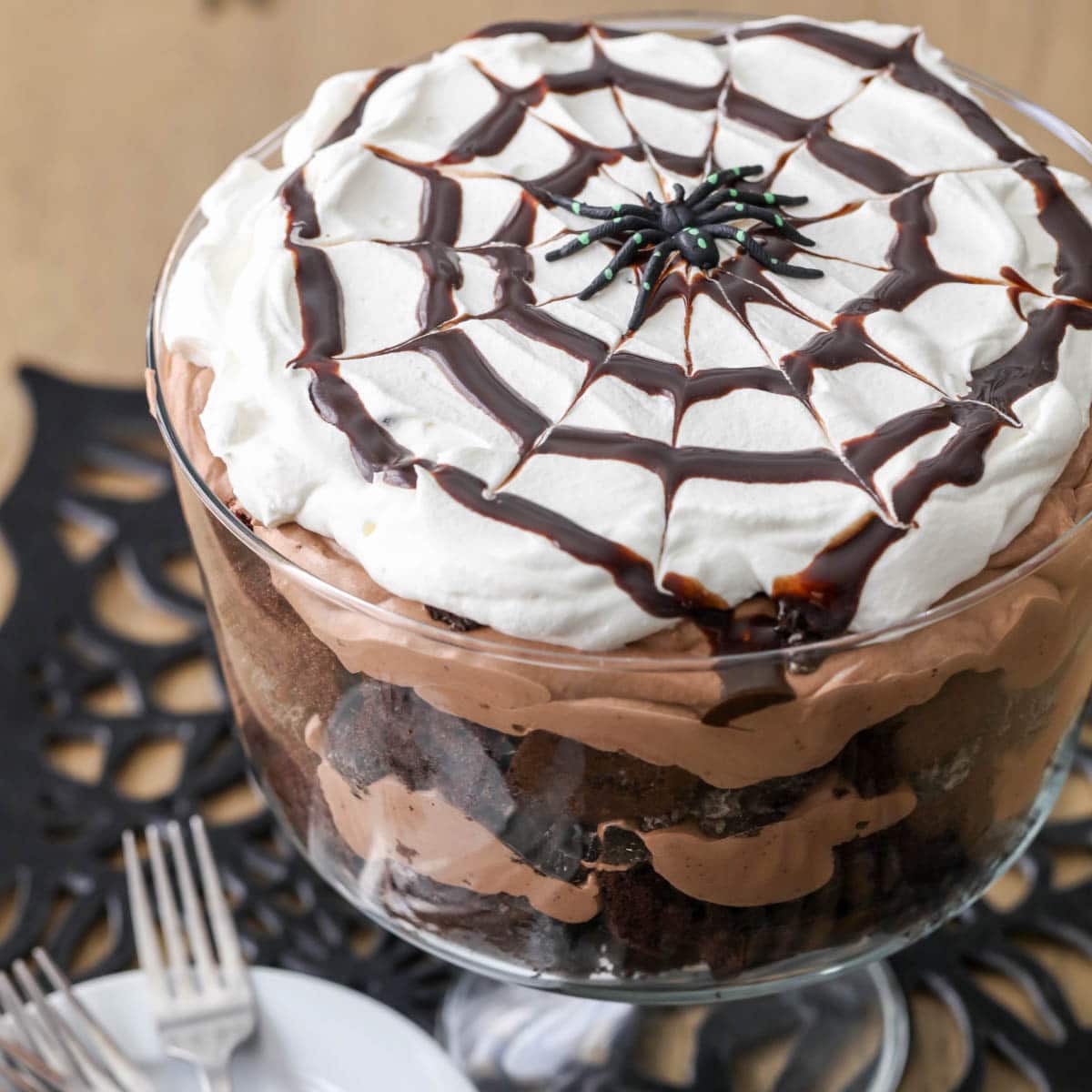 chocolate spider trifle topped with a spider  in a glass dish