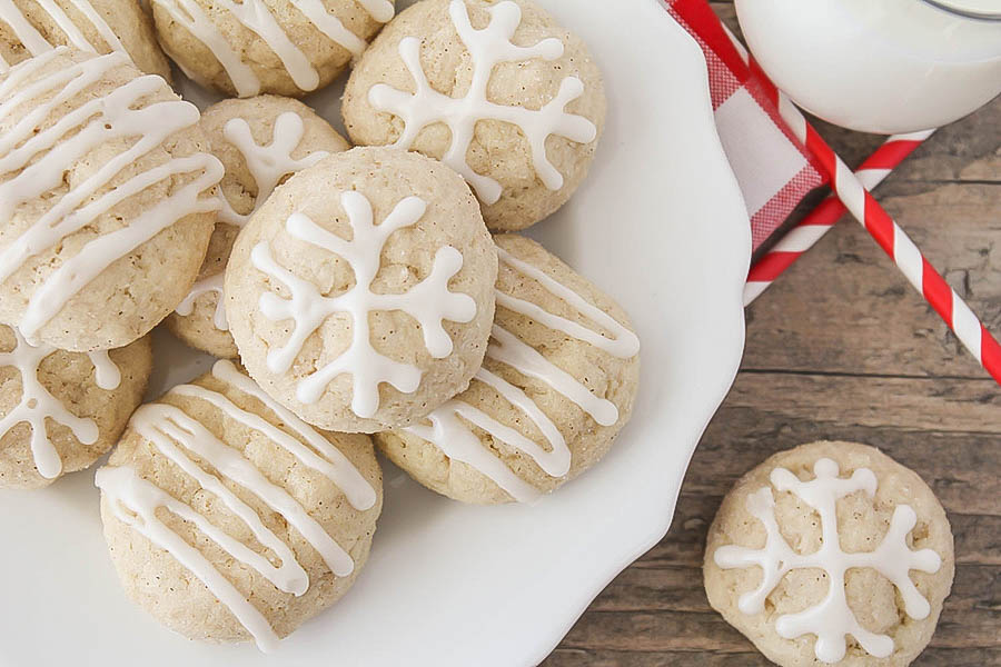 A bunch of cookie dough balls are sitting on a plate.