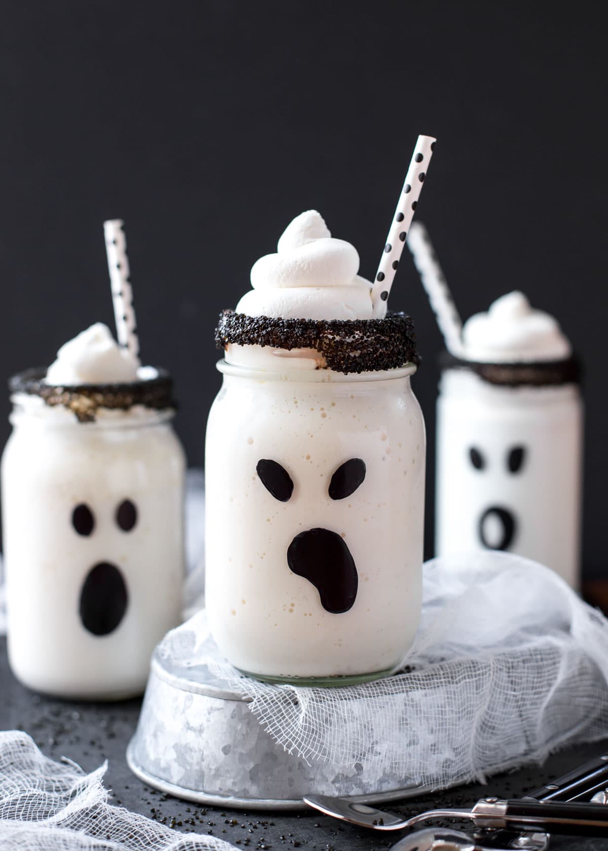 Boo-nilla milkshakes in decorated mason jars topped with whipped cream