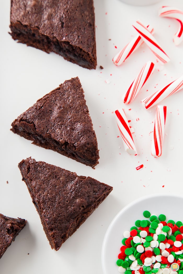 Brownies cut into triangles with candy canes for decorating.