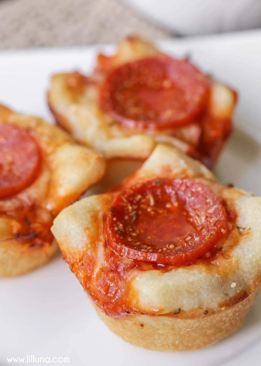 Party appetizers - close up of mini deep dish pizzas topped with pepperoni.