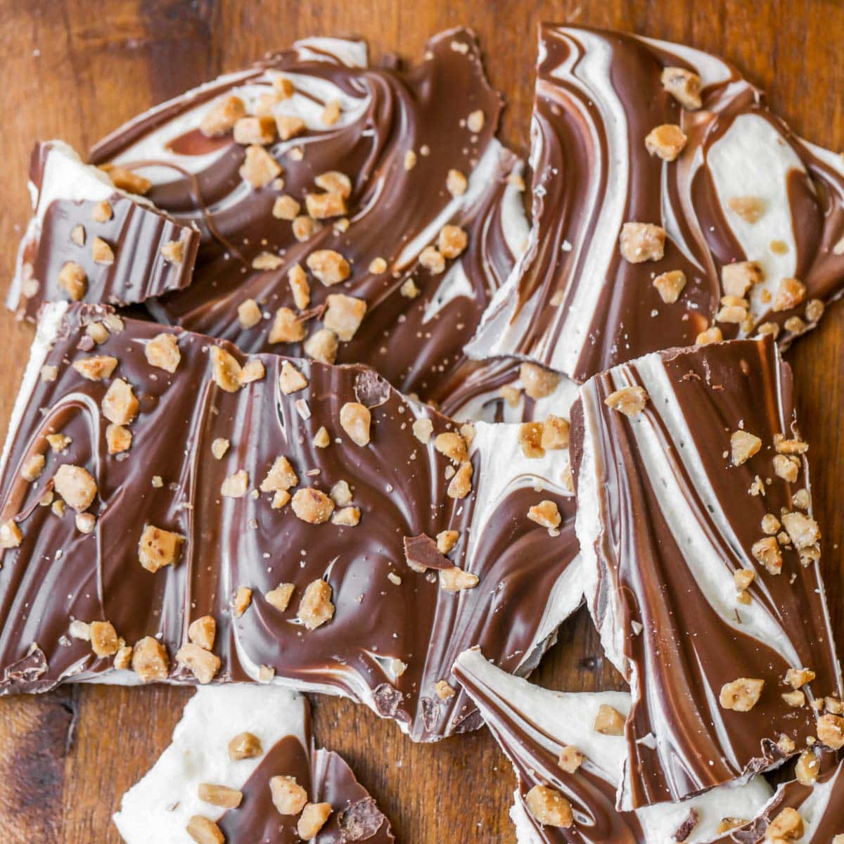 Marbled Peppermint Bark broken in pieces on a wooden table