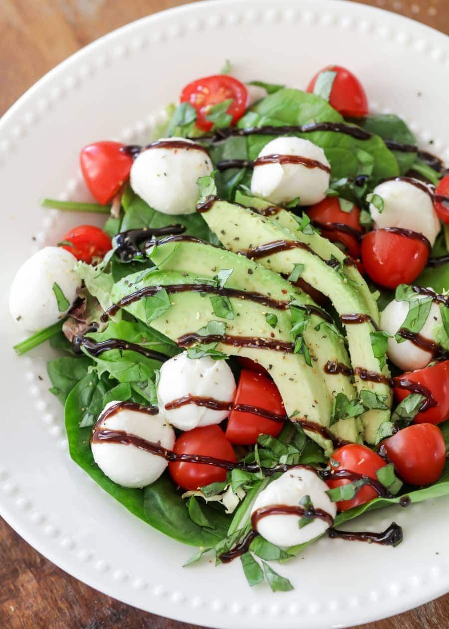 a white bowl filled with easy caprese salad