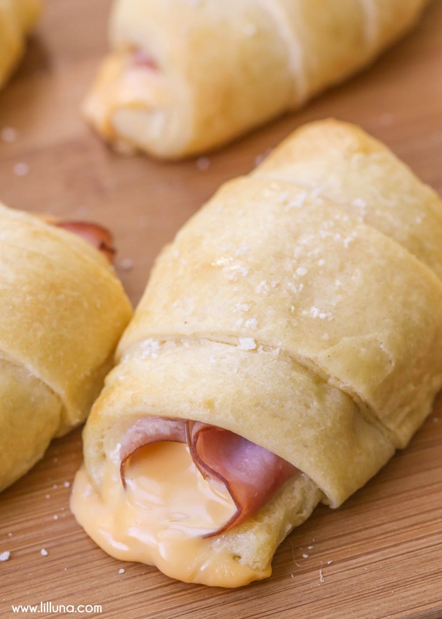 Ham Roll Ups on a wooden cutting board