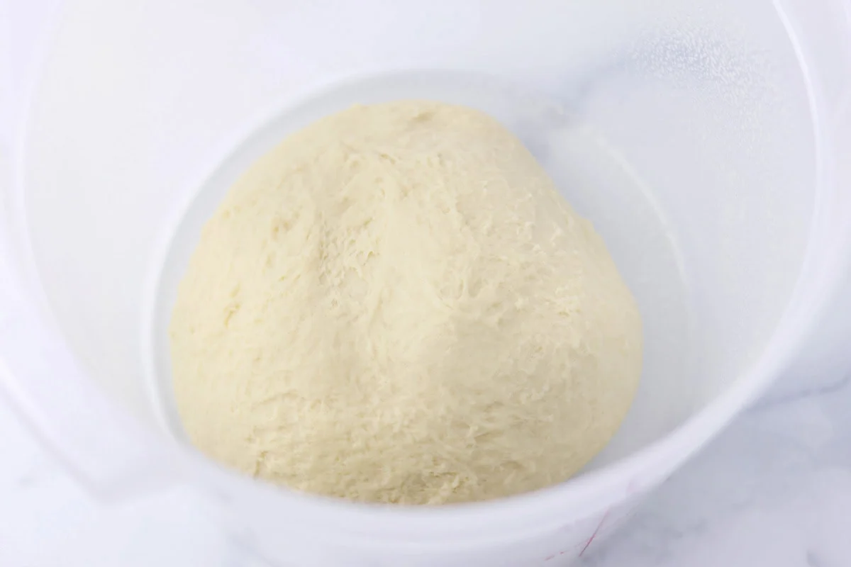 Orange rolls dough in container.