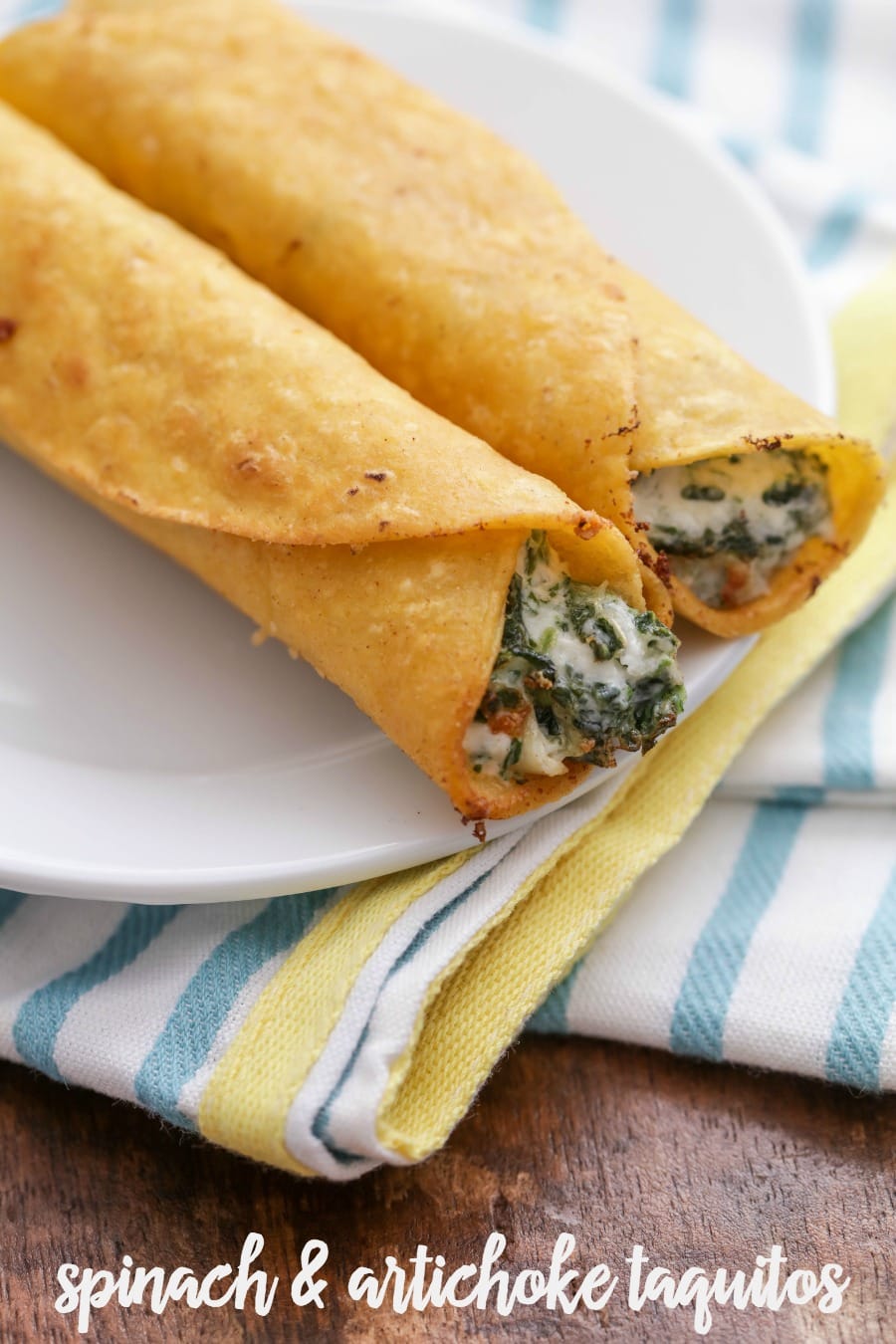 Cheesy Spinach and Artichoke Taquitos fried and served on a white plate