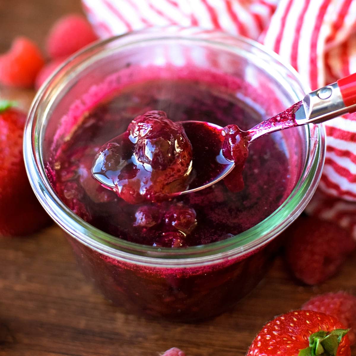 Berry sauce in a glass jar to serve on top of white chocolate berry pancakes