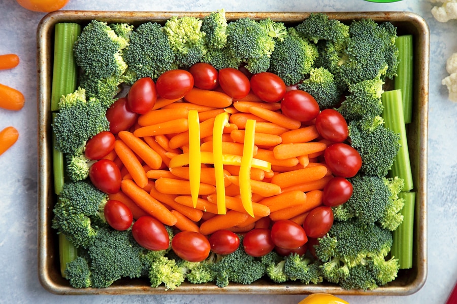A game day veggie tray with the vegetables arranged to look like a football