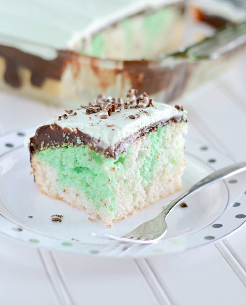 slice of mint cake topped with fudge and mint cream