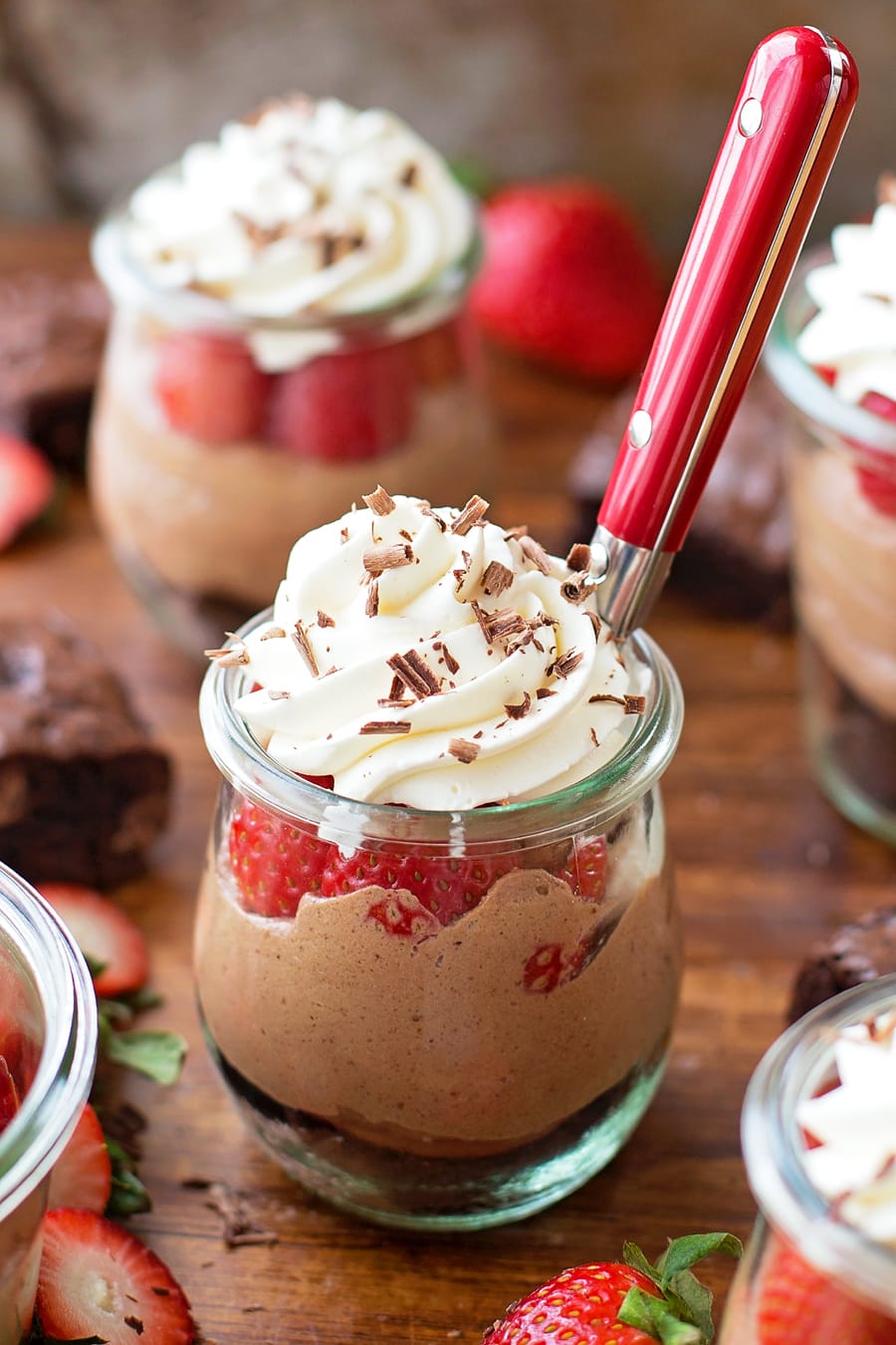 No-Bake Strawberry Nutella Cheesecakes topped with whipped cream and chocoalte shavings