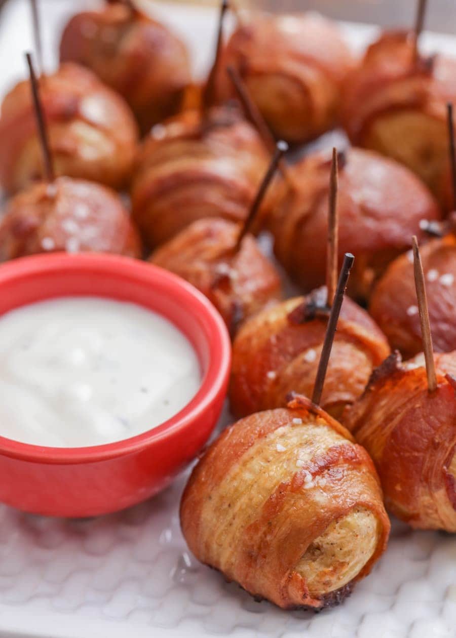 Finger food appetizers - bacon wrapped potatoes served with dressing.