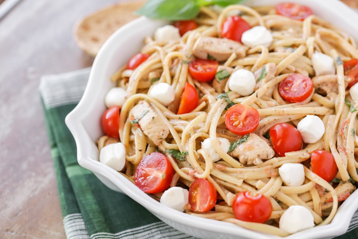 Bruschetta chicken pasta in a decorative white bowl.