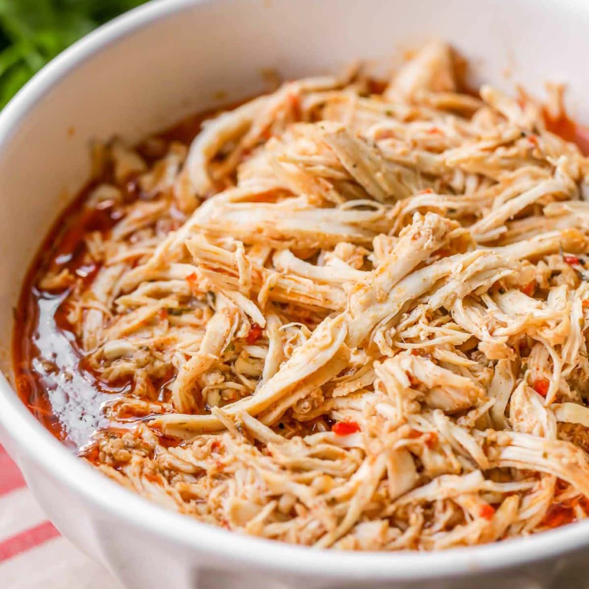 5 Ingredient Recipes - Cafe rio shredded chicken served in a white bowl.