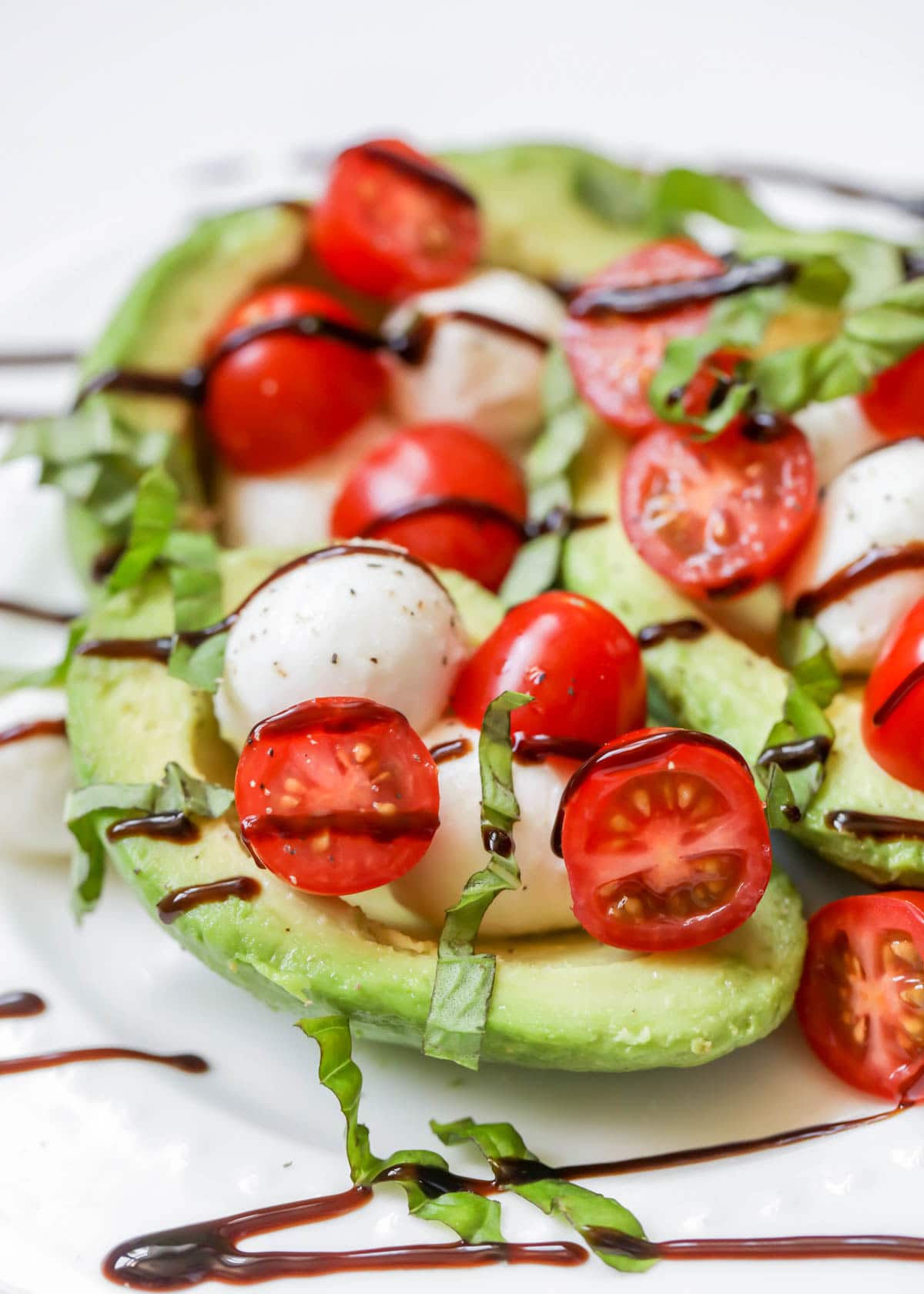 Caprese Stuffed Avocados served on a white plate
