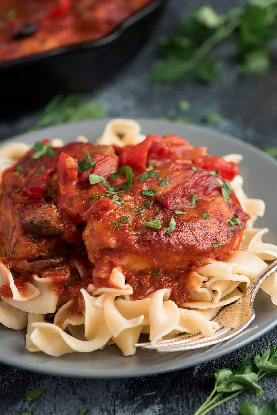 Easy Chicken cacciatore on grey plate served over pasta