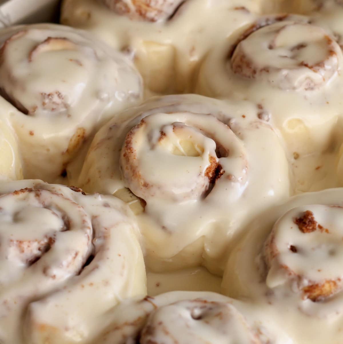 Close up of frosted Cinnamon Rolls in a pan.