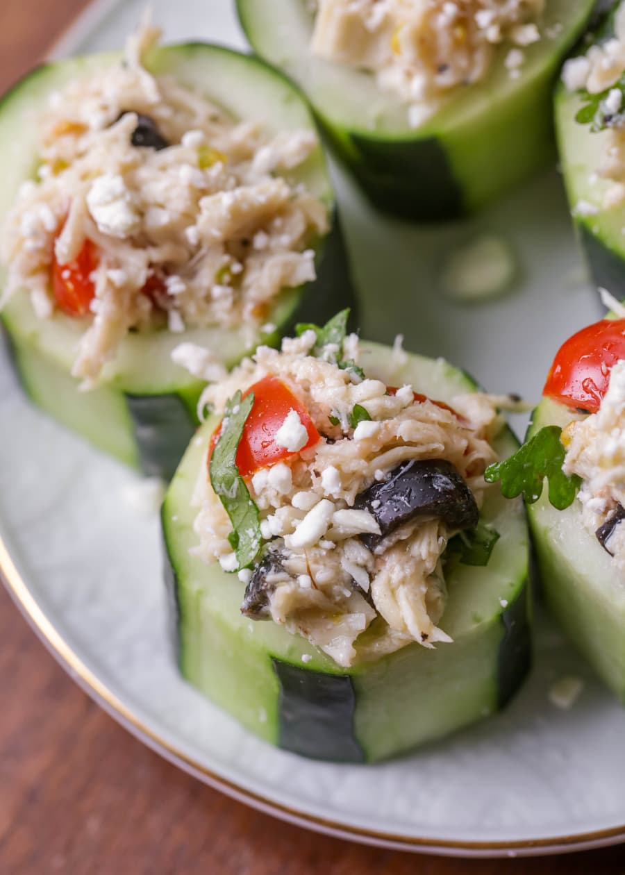 Party appetizers - close up of greek cucumber cups served on a white plate.