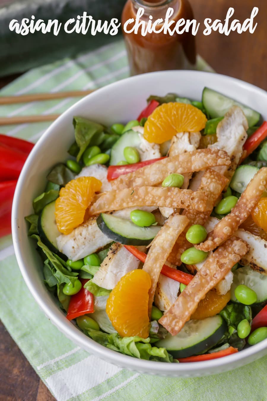 Wonton topped asian citrus salad in a white bowl