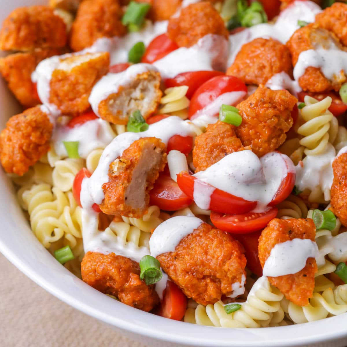 Buffalo chicken pasta salad served in a white bowl.