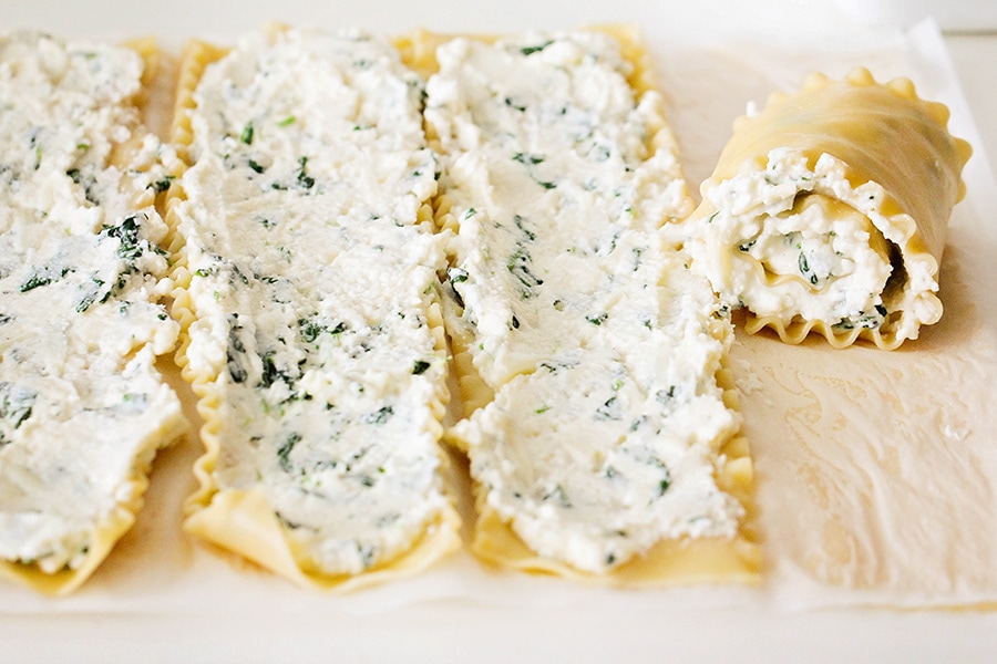 Spinach Lasagna Rolls being filled with cheese mixture.