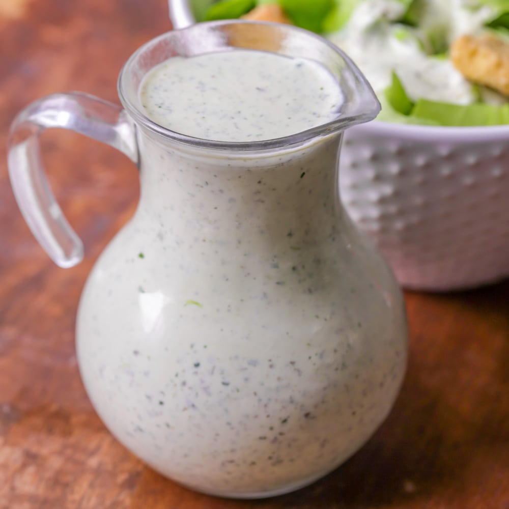 Pesto salad dressing in container