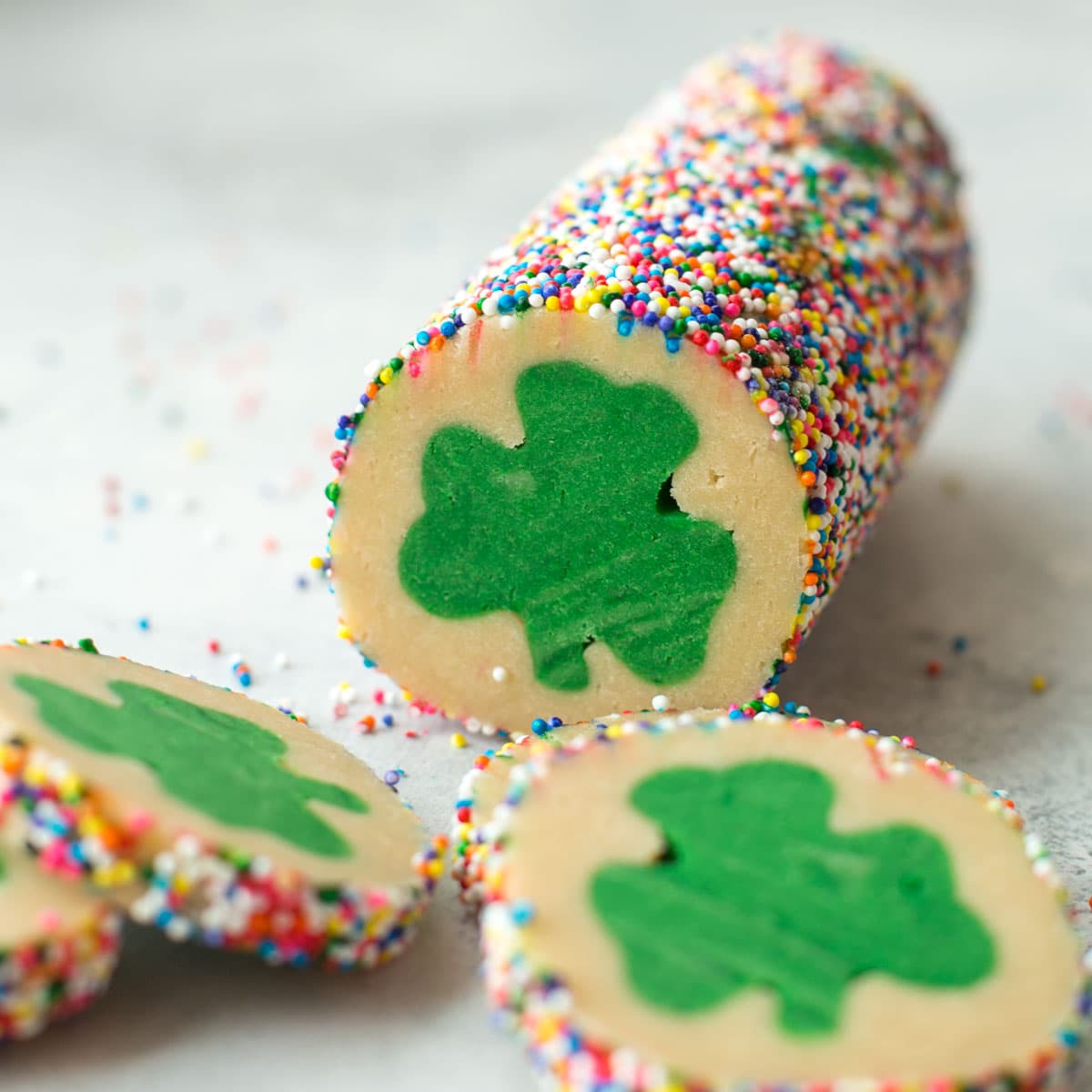 Slicing cookies out of of the dough log for St. Patrick's Day cookies.