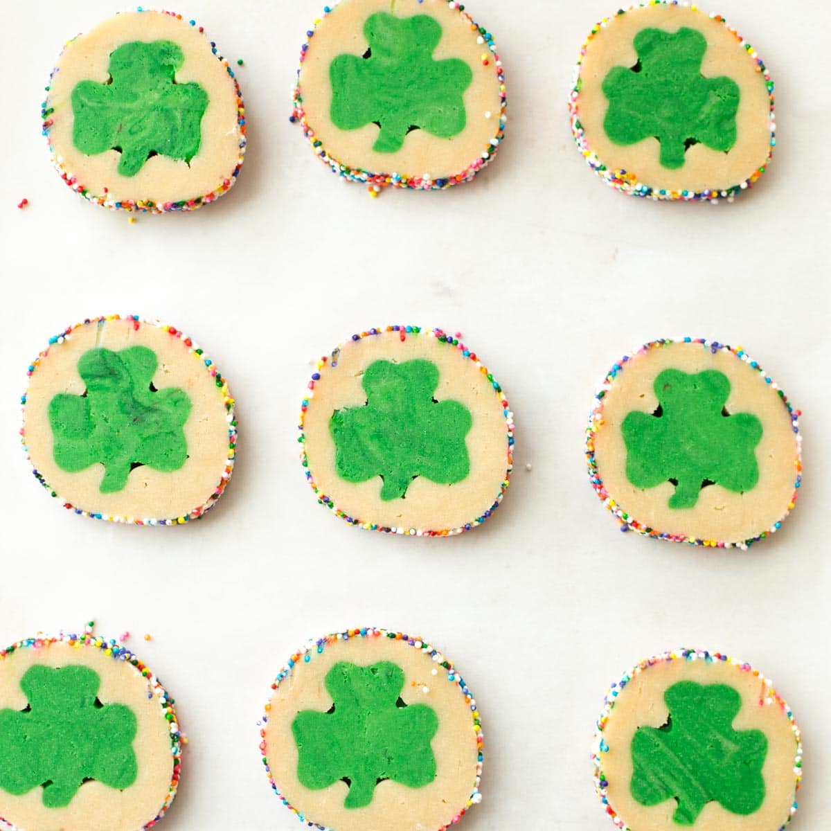St Patricks day cookie dough slices on a baking sheet.