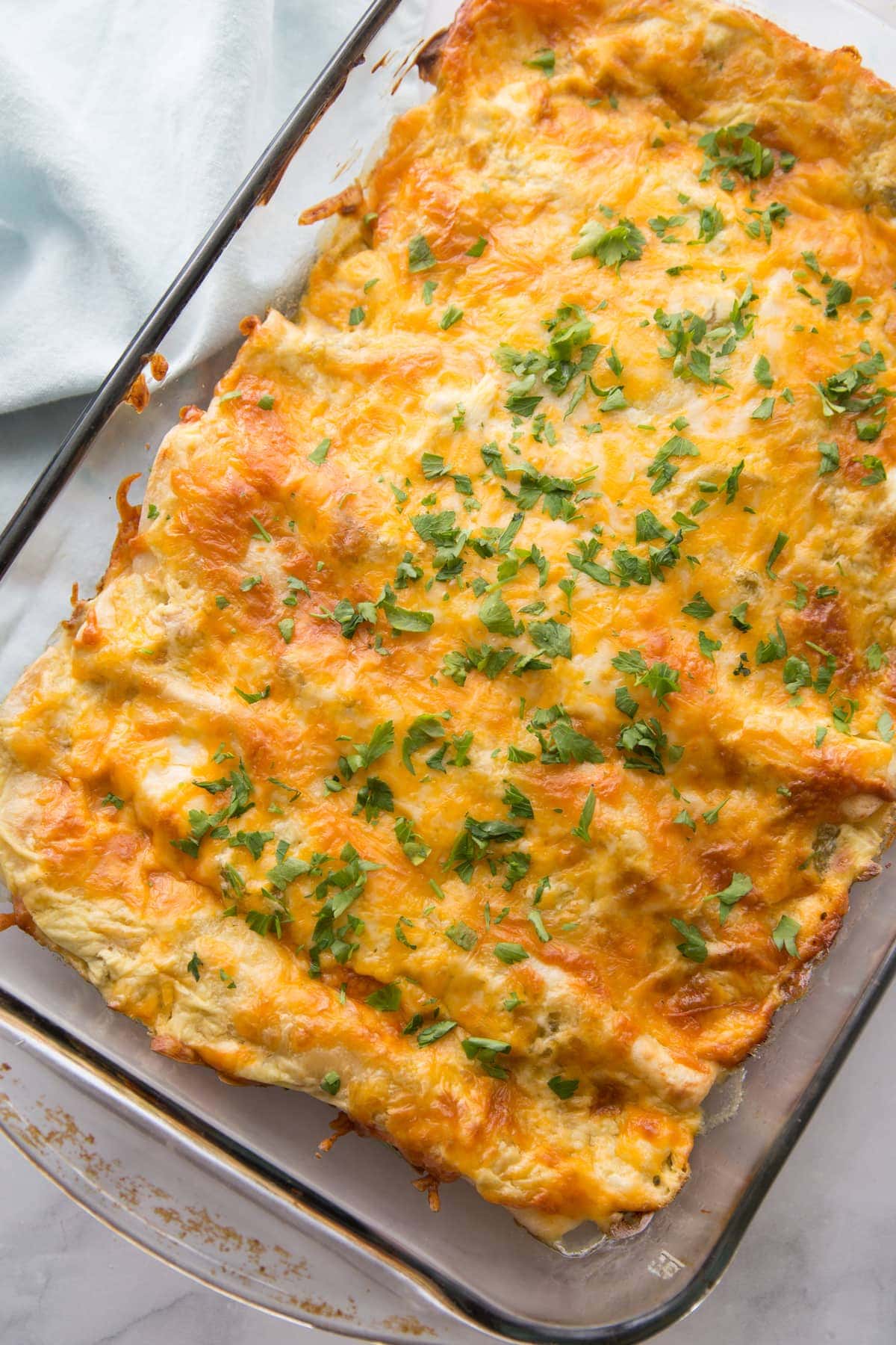 Sour Cream Chicken Enchiladas recipe in casserole dish.