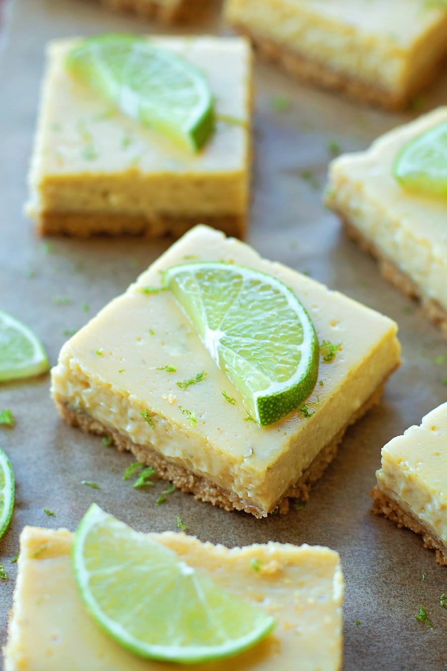 Key Lime Pie Bars sliced and topped with lime slices