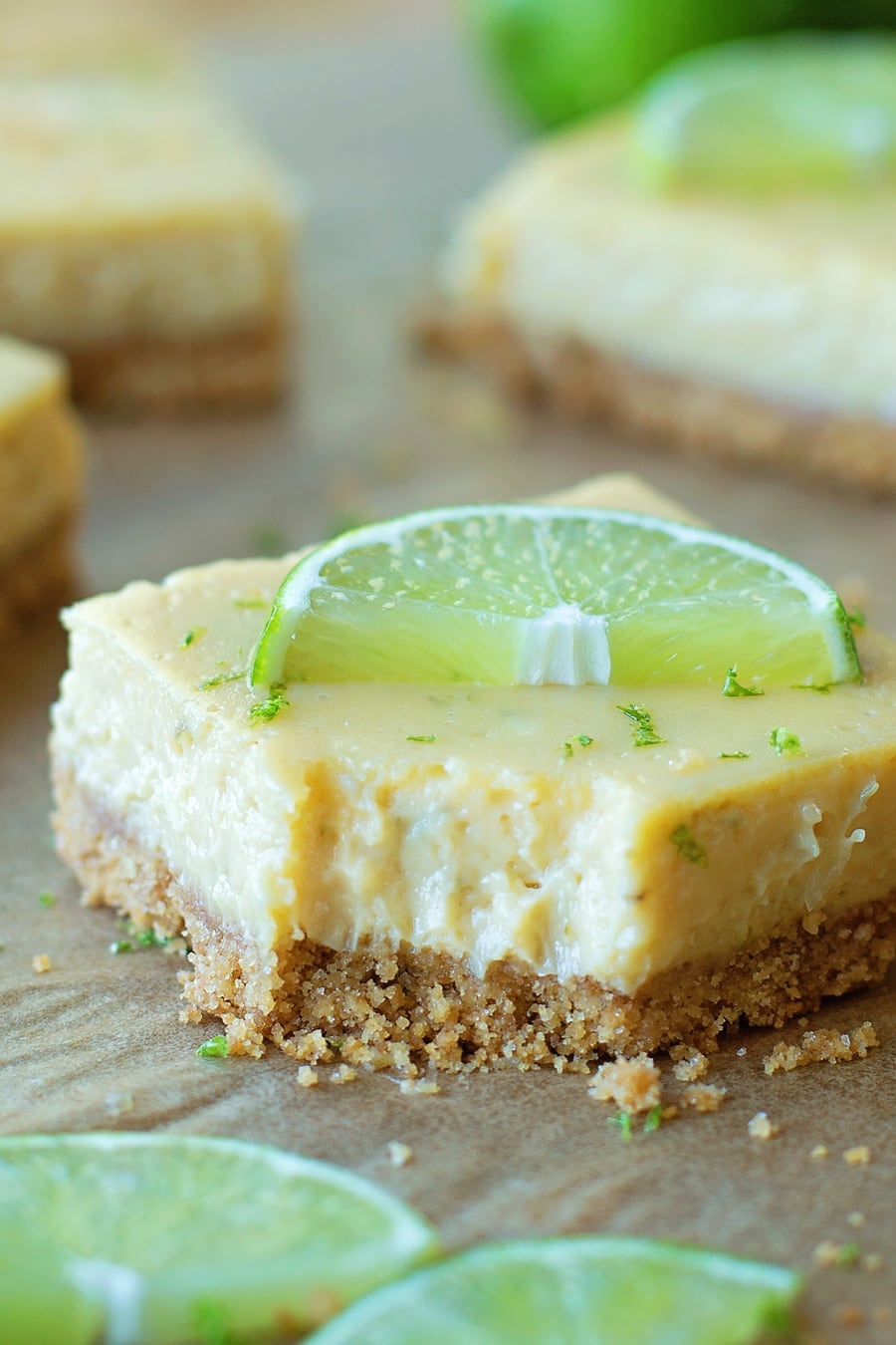 Key Lime Pie Bars topped with slices of lime