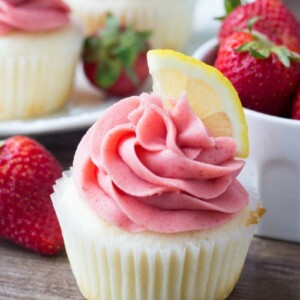 These Strawberry Lemonade Cupcakes are so pretty and perfect for spring or summer. They start with fluffy, moist lemon cupcakes. Then they're topped with strawberry frosting made from fresh berries!
