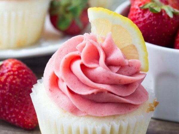 These Strawberry Lemonade Cupcakes are so pretty and perfect for spring or summer. They start with fluffy, moist lemon cupcakes. Then they're topped with strawberry frosting made from fresh berries!