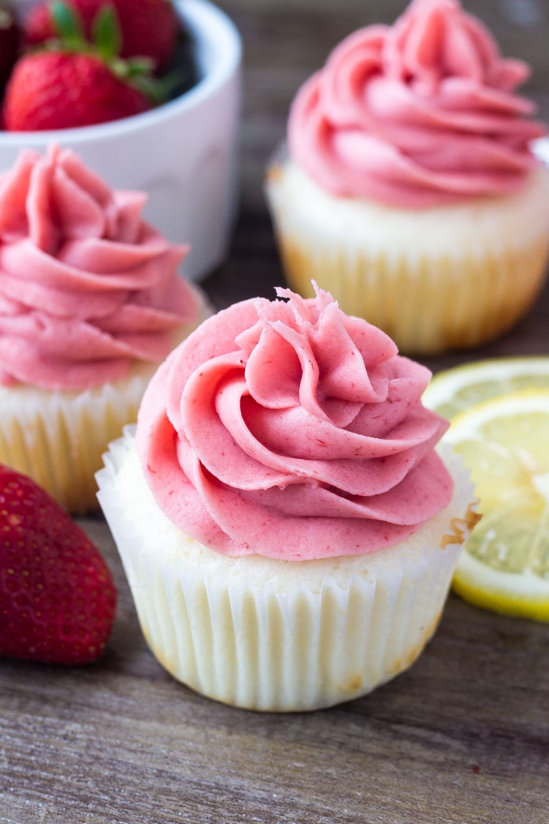 Strawberry Lemonade Cupcakes displayed on a wooden table