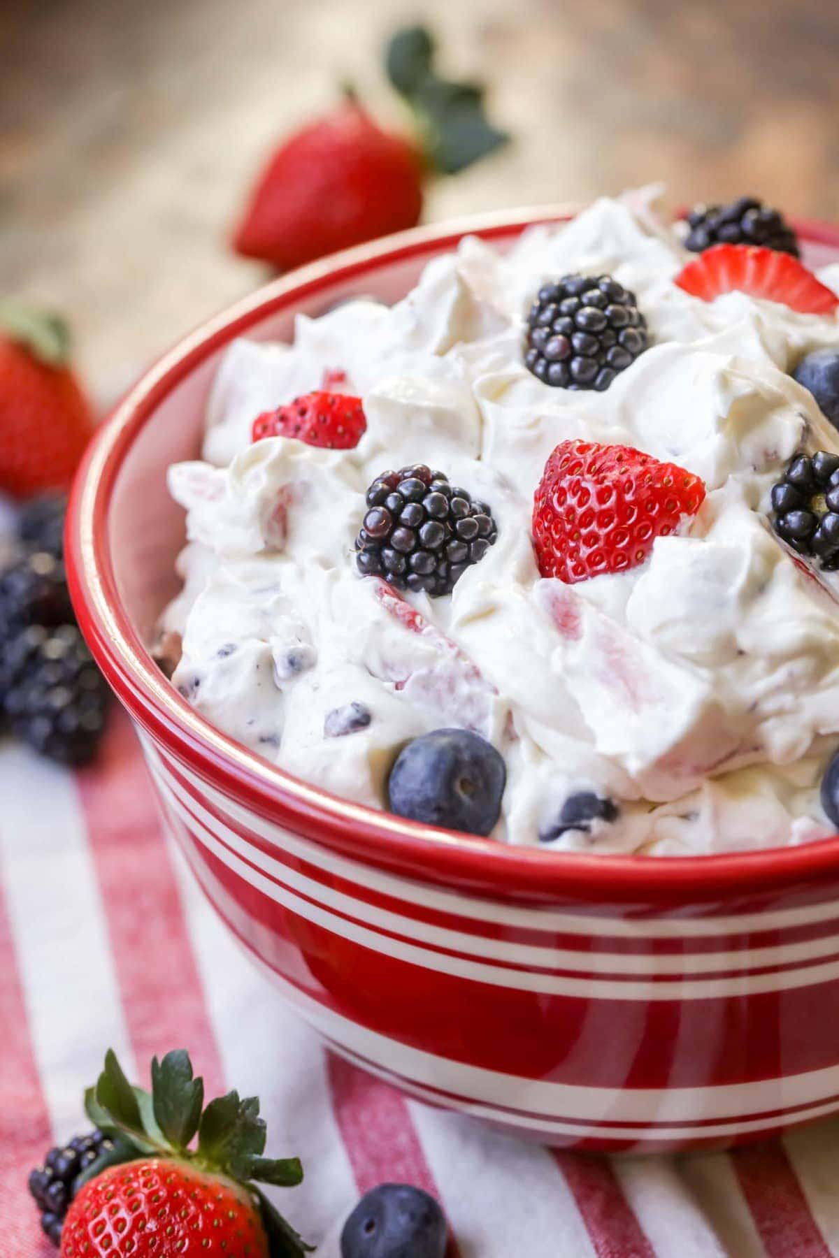 Cream cheese fruit salad served in a bowl.