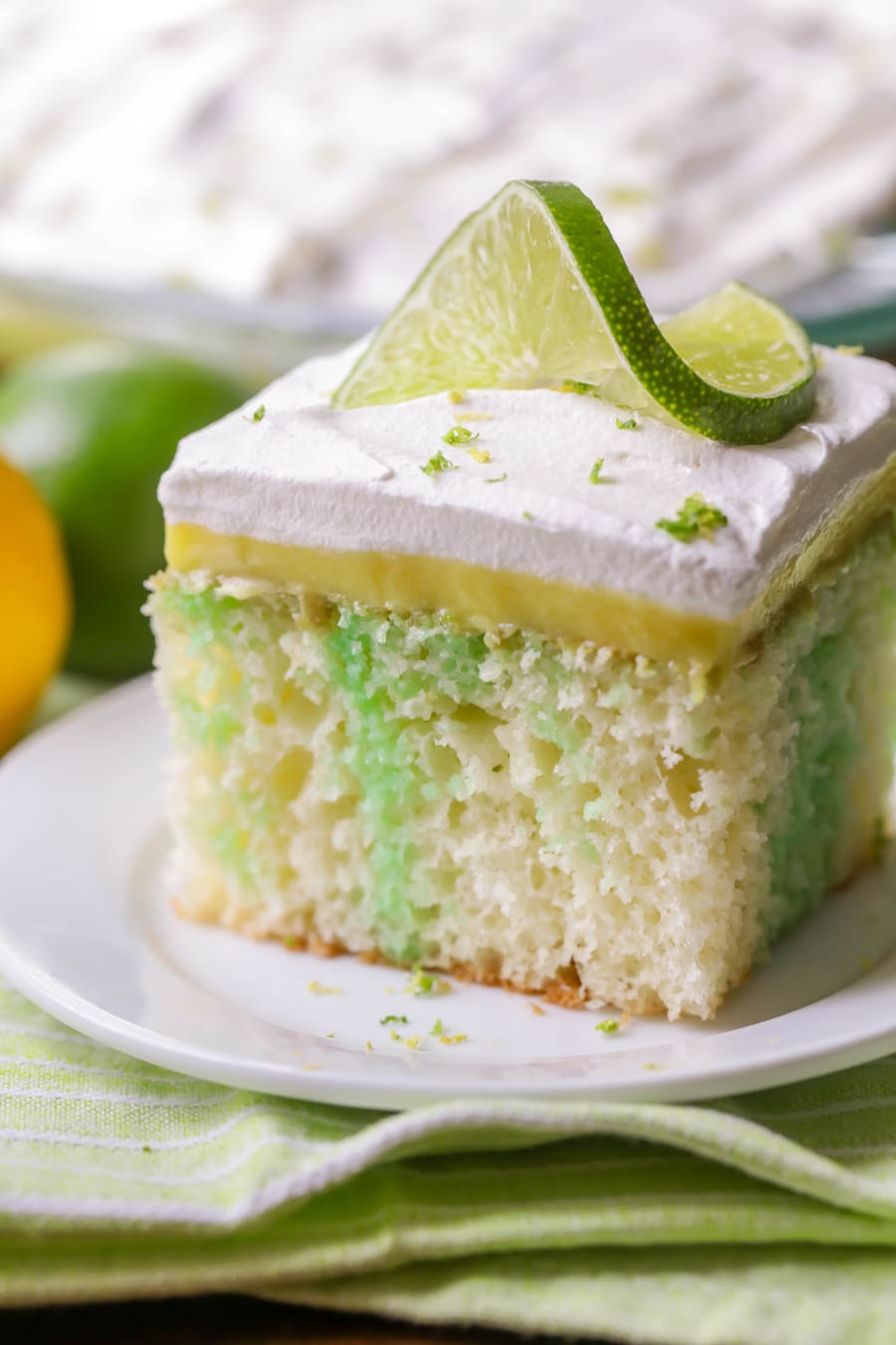 Lime twist topped slice of lemon lime poke cake