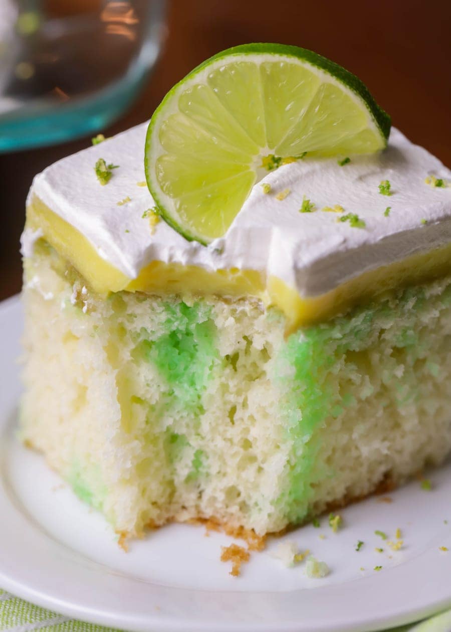 bite of a slice of lemon lime poke cake