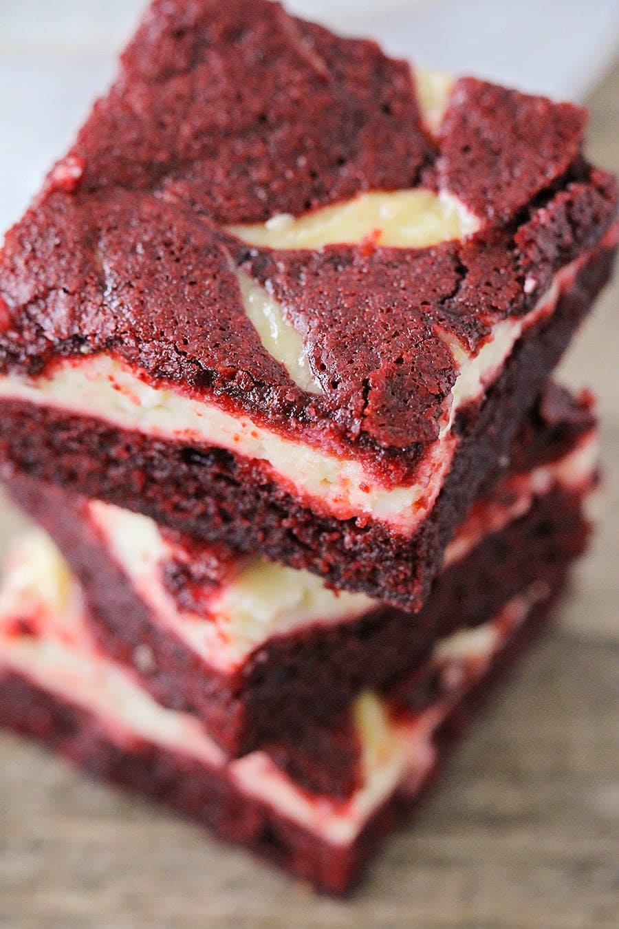 Red Velvet Cheesecake Brownie recipe sliced and stacked.
