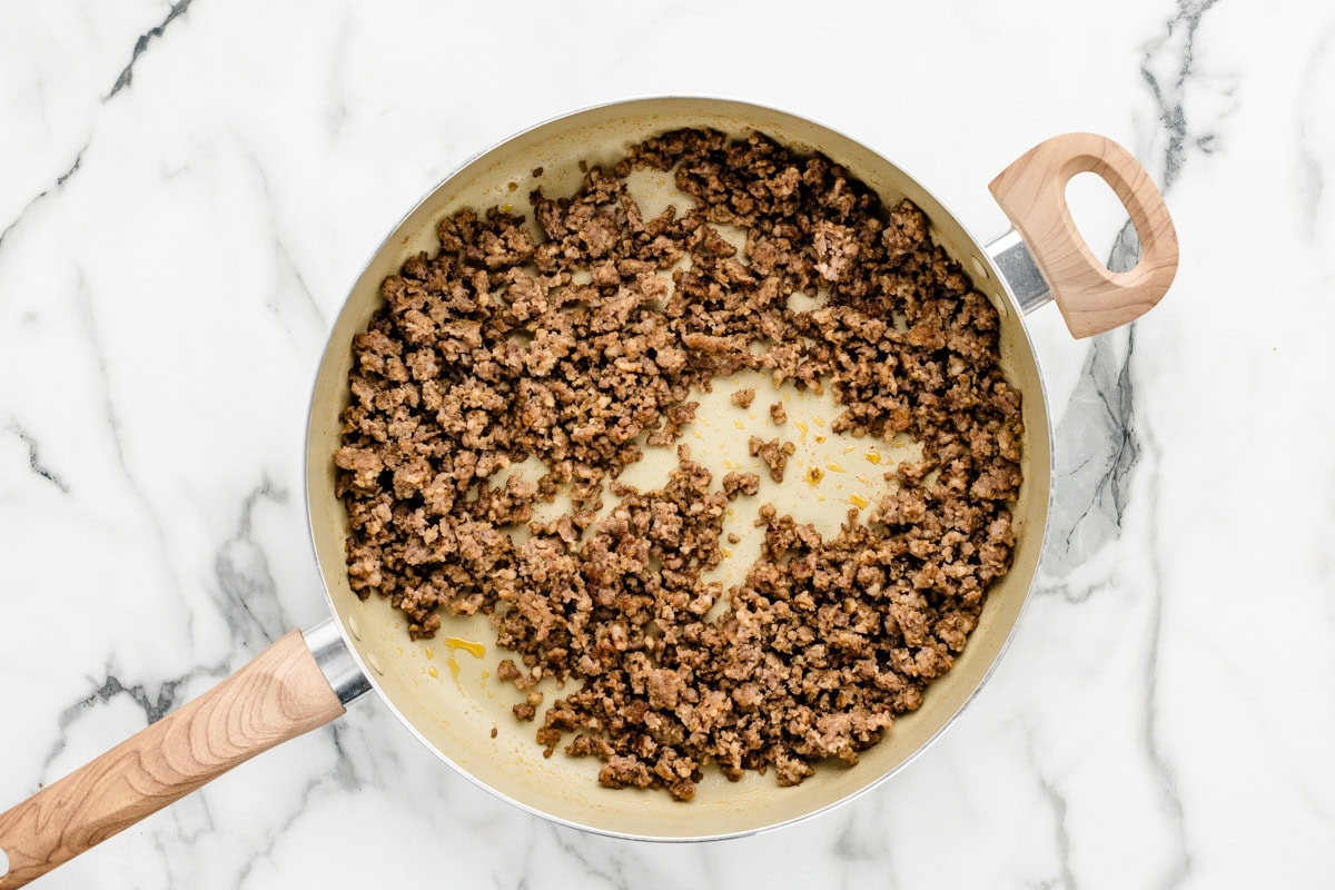 Sausage being cooked in skillet.