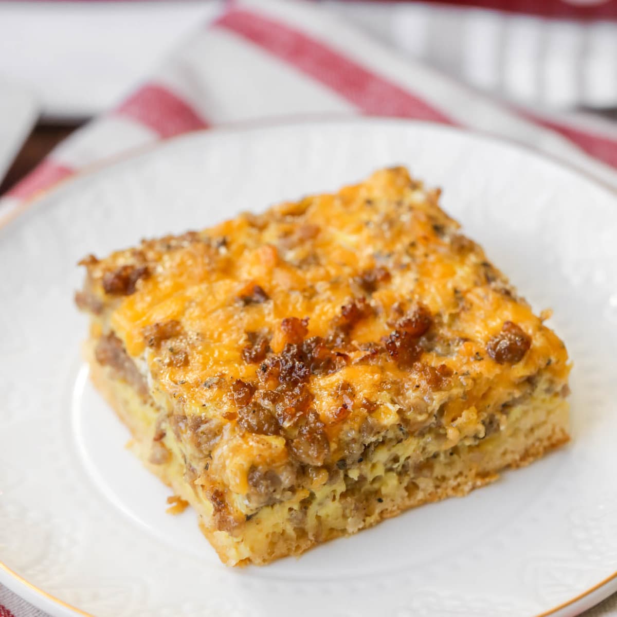 Christmas breakfast ideas - a square slice of sausage breakfast casserole on a white plate.