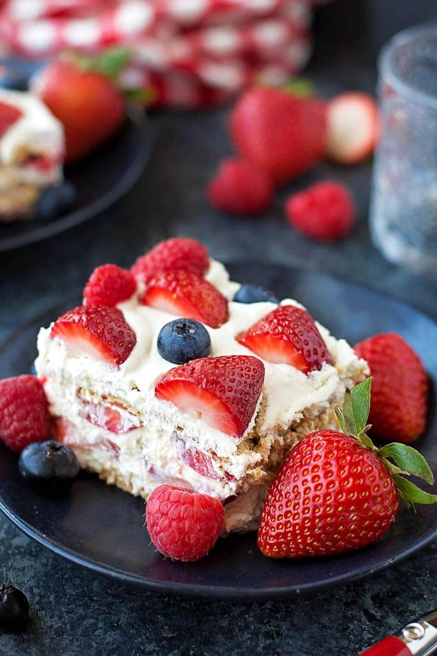 No-Bake Berry Icebox Cake sliced and served on a black plate