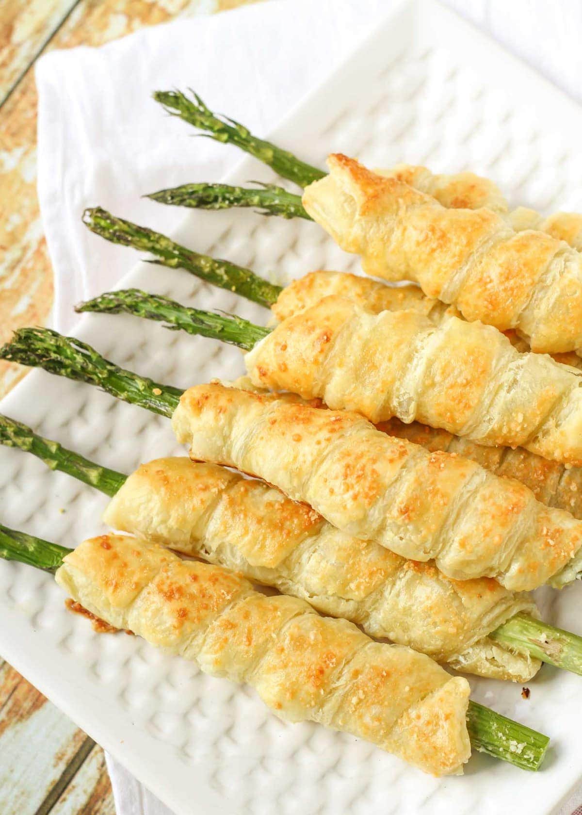 Asparagus roll ups on white plate