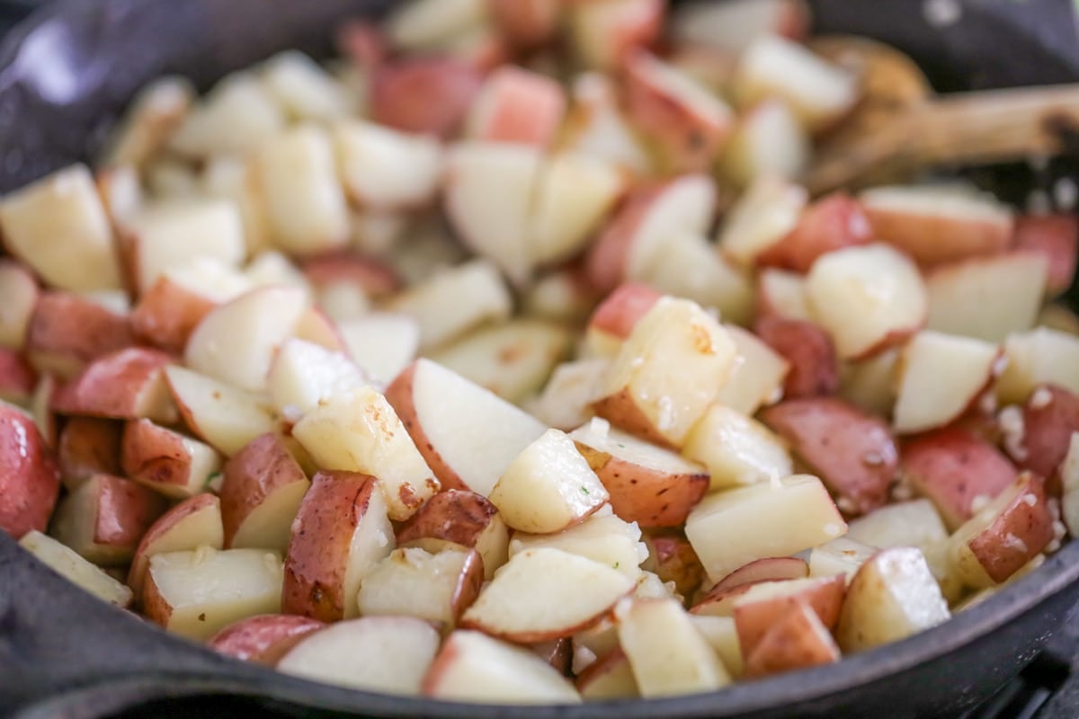 Breakfast potatoes roasting in skillet.