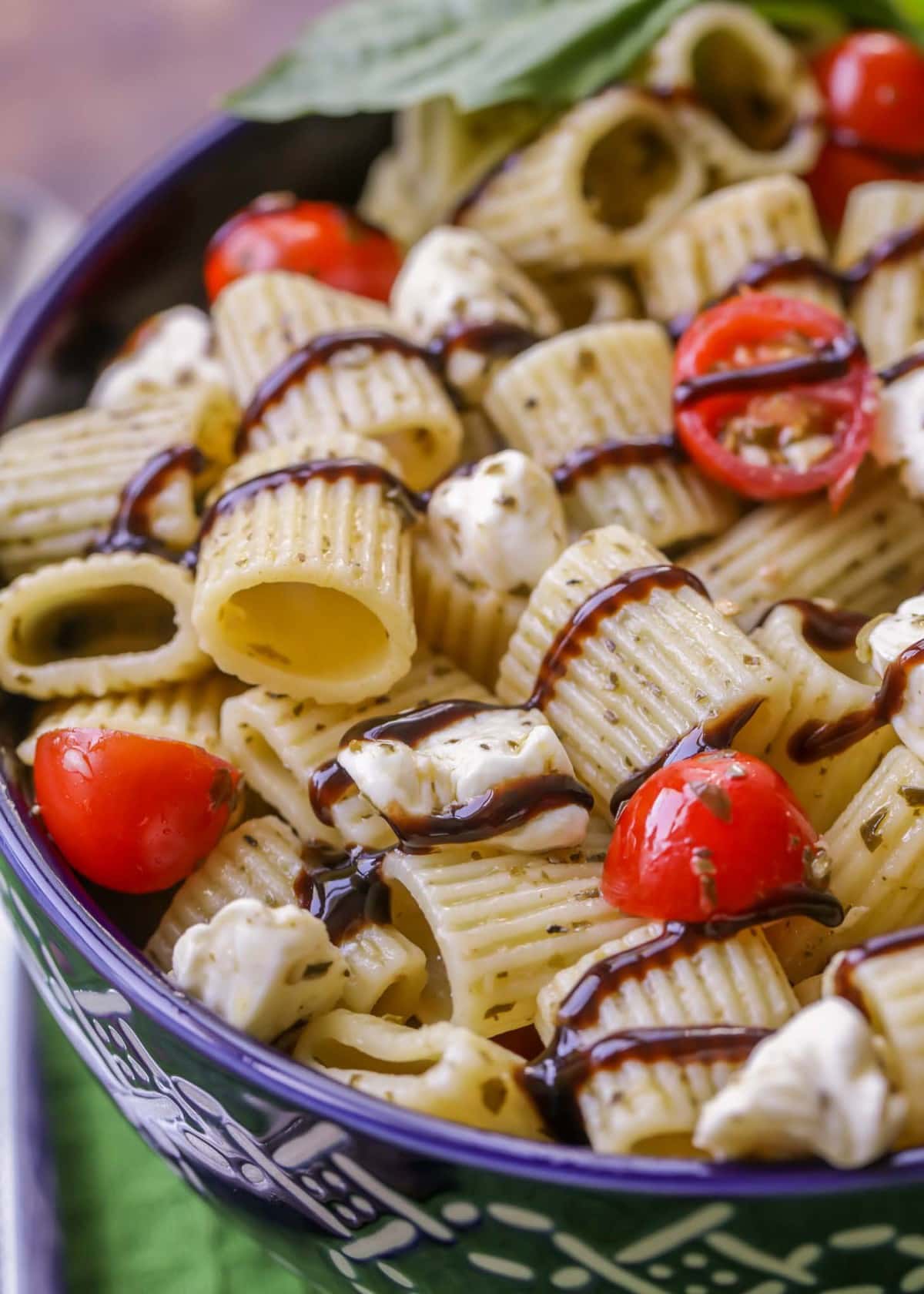 Caprese Pesto Pasta Salad served in a blue bowl