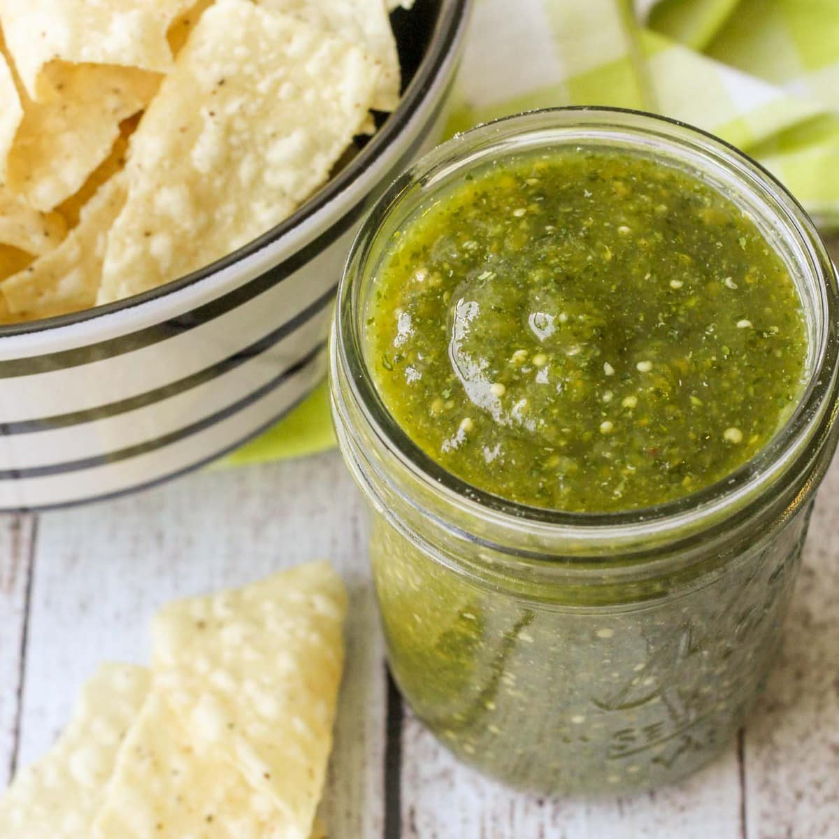 Cold appetizers - a jar of salsa verde served with tortilla chips.