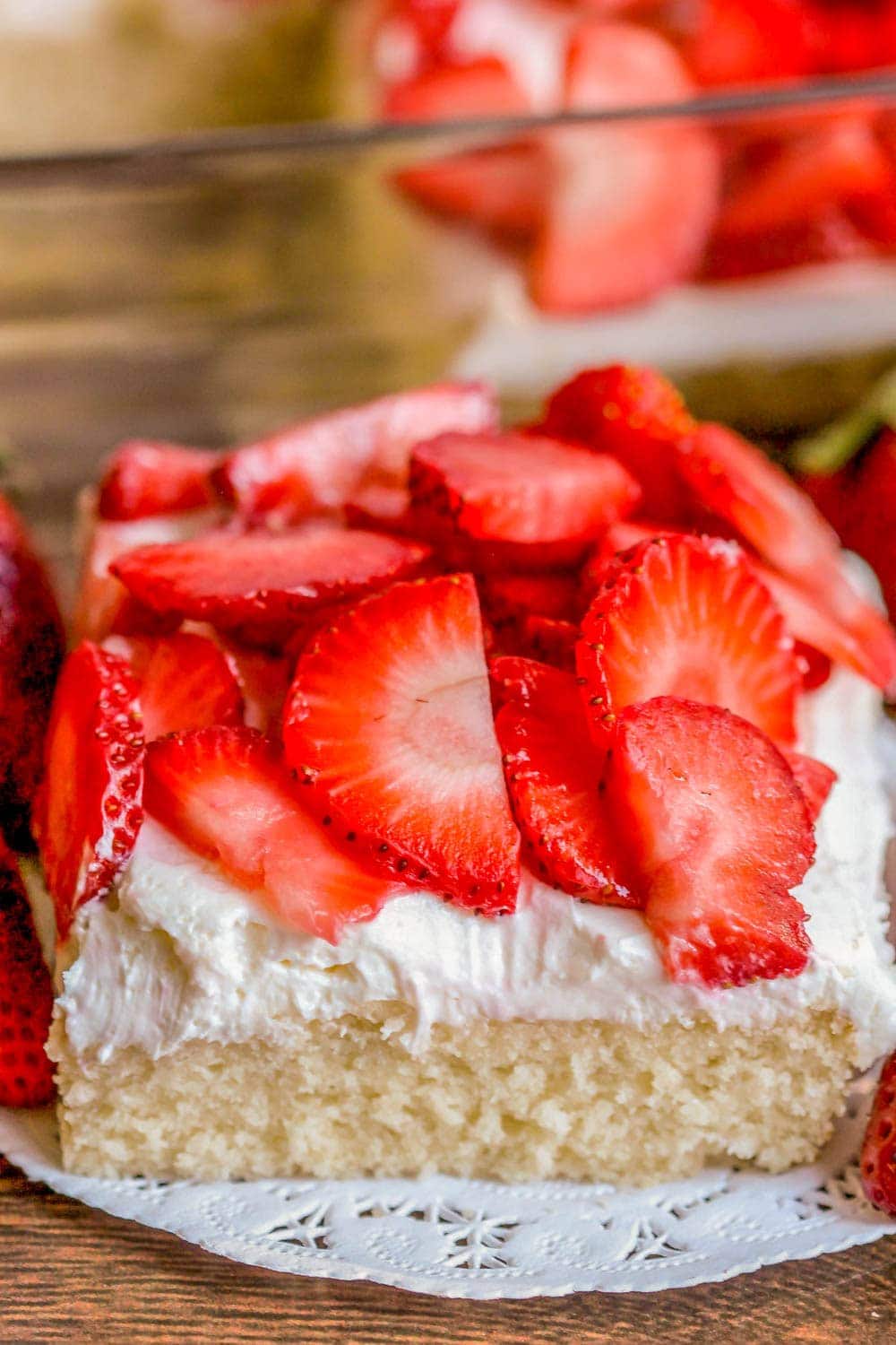 Strawberry shortcake bars sliced and served on a white doily.