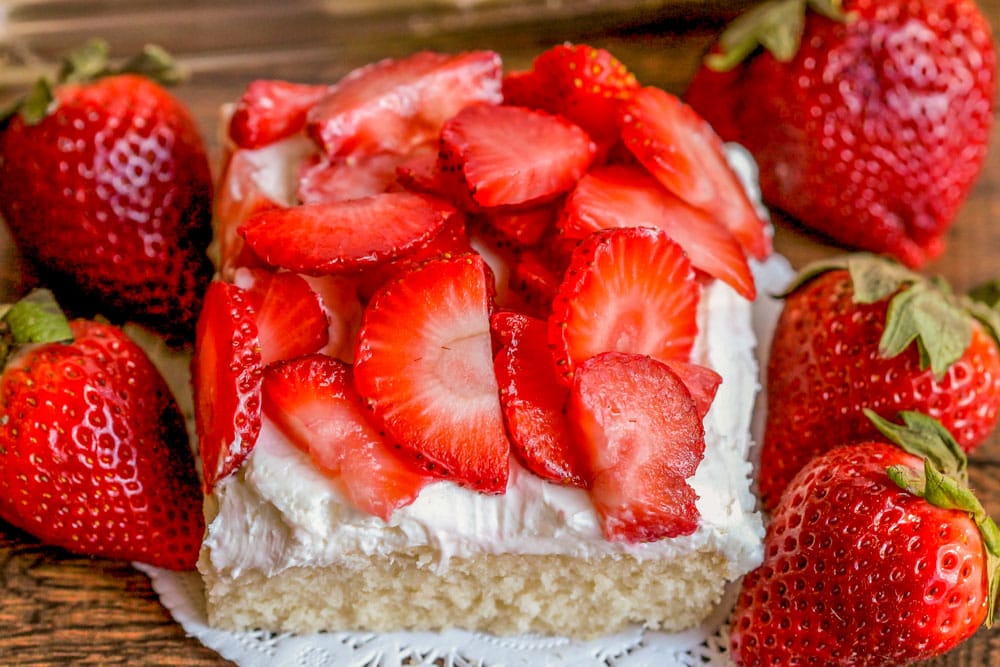 Strawberry shortcake bars sliced and squares and topped with fresh strawberries.