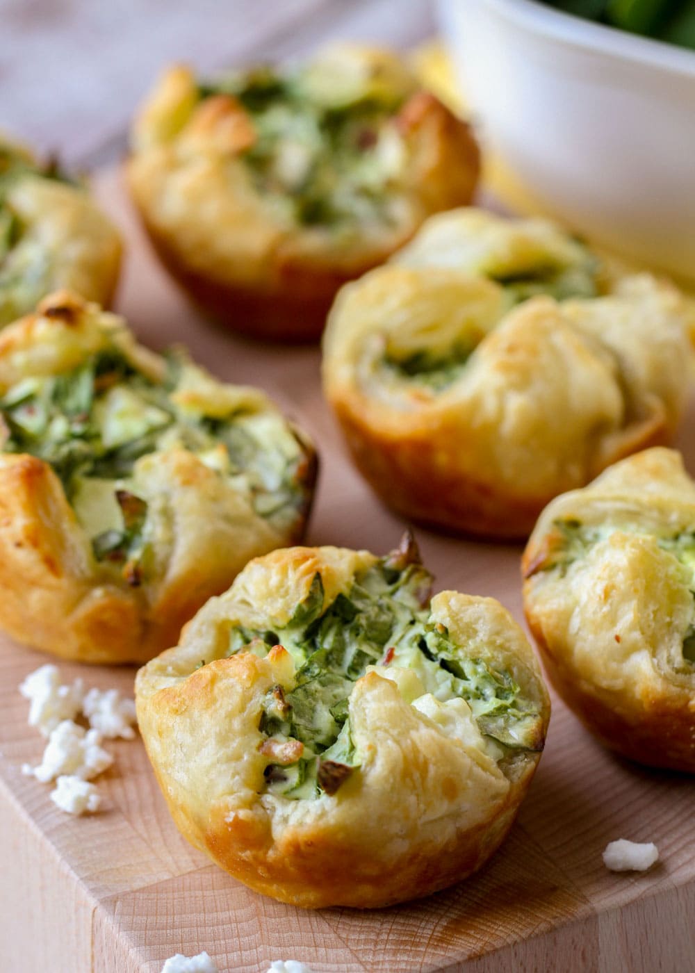 Spinach puffs recipe served on a wooden block.