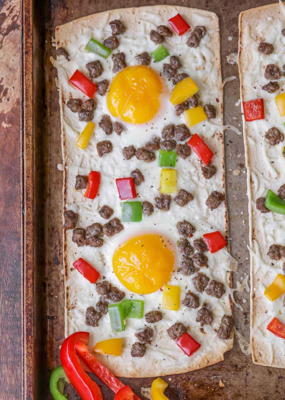 Delicious Healthy Flatbread Breakfast Pizzas topped with sausage and peppers.