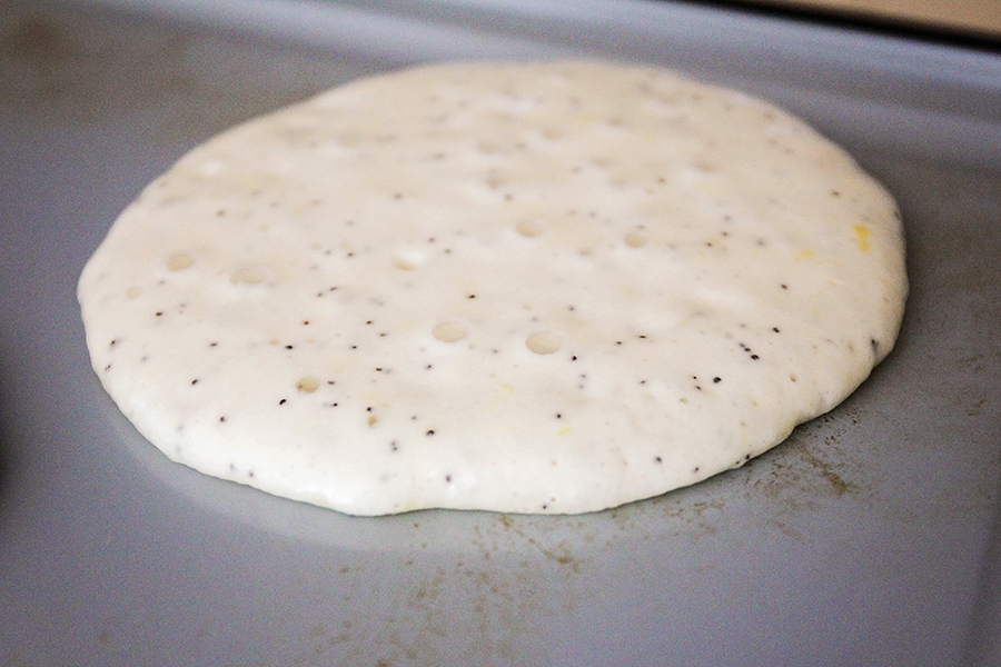 Cooking a lemon poppyseed pancake on a griddle