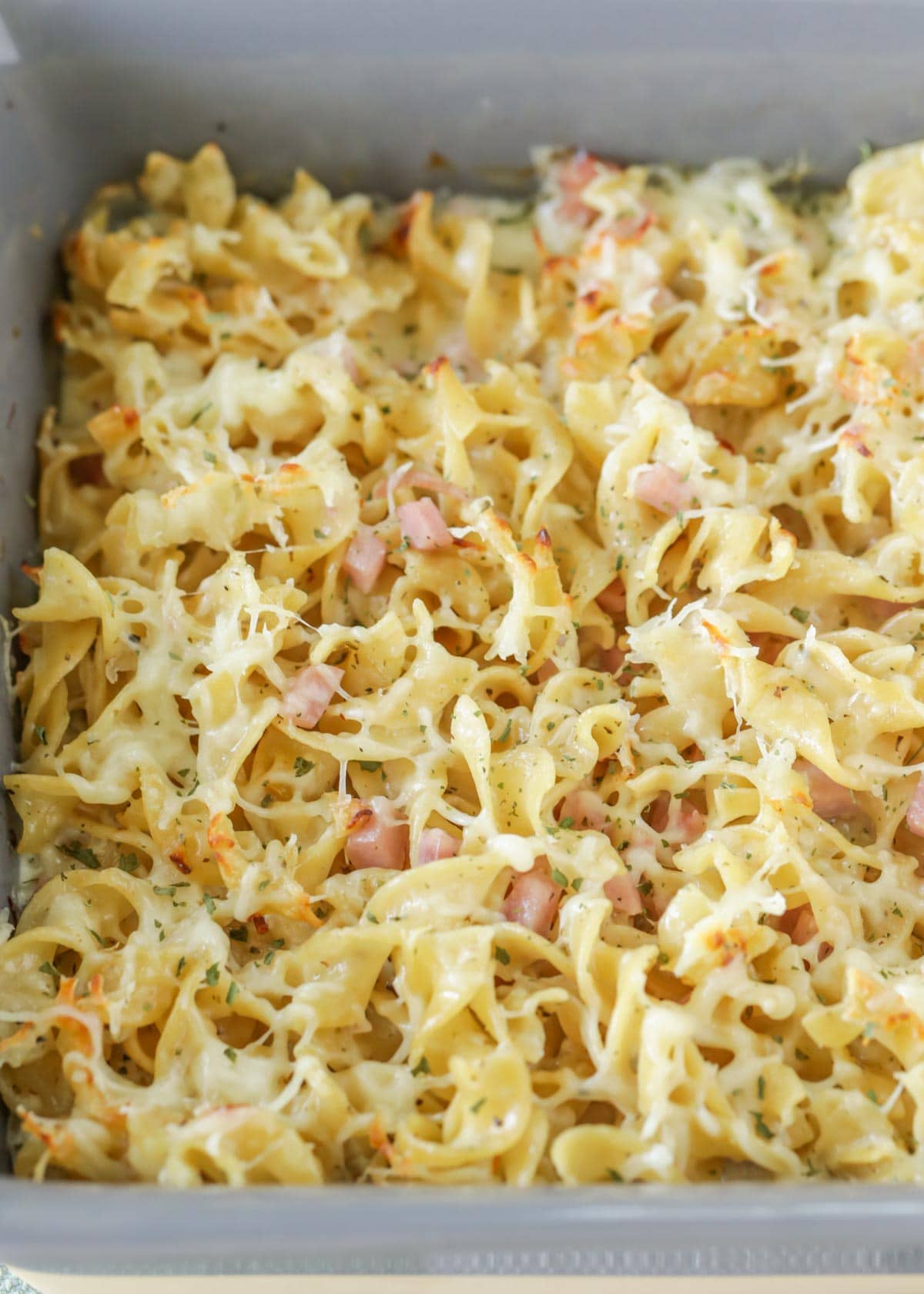 Macaroni and cheese with ham in a baking dish.